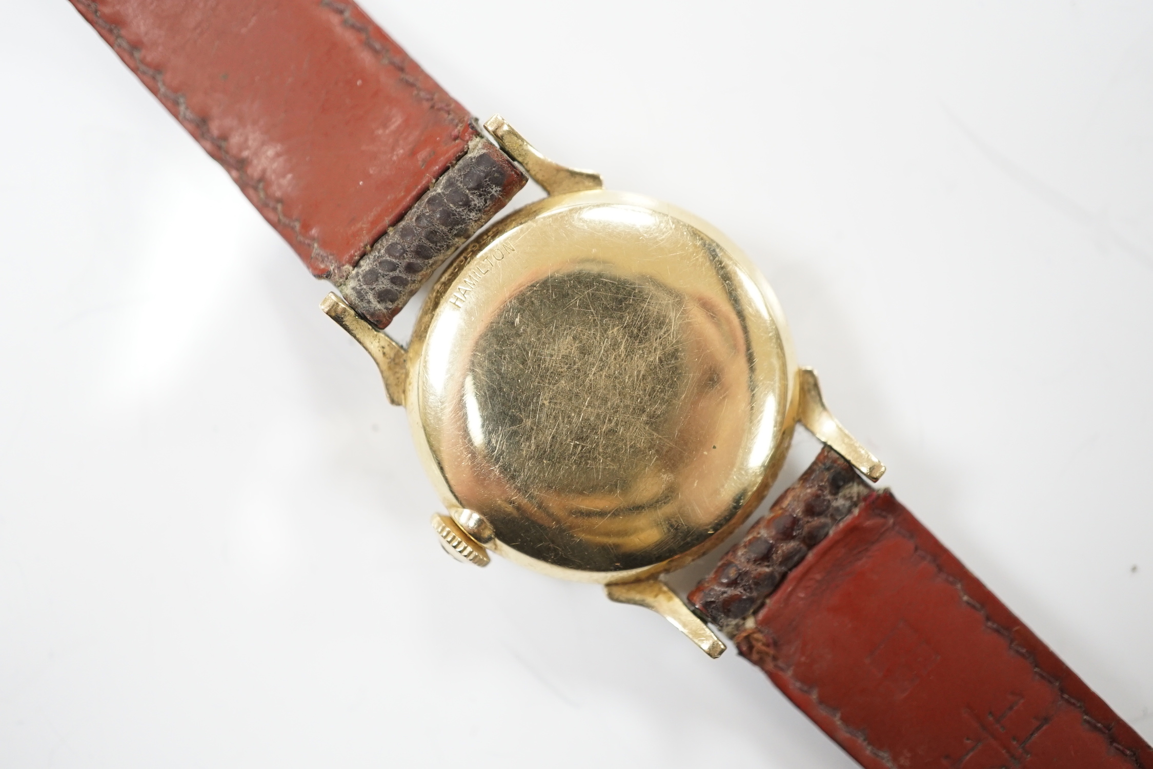 A gentleman's 14k Hamilton manual wind wrist watch, with Arabic dial, on associated leather strap.